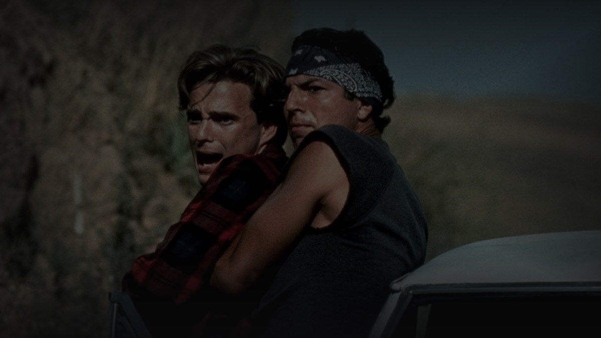 Still from Blood In Blood Out (1993) — letterboxd still (1200x675 crop, key hUN8HJhcNpHOU0ldcaDG1dTsapR); genuine film frame, cross-checked against tmdb movie 9702 backdrop #6 (same key). source luma 115.1, pre-darkened 0.70, baked at factor 0.45, 1200x675, on-disk luma 28.1